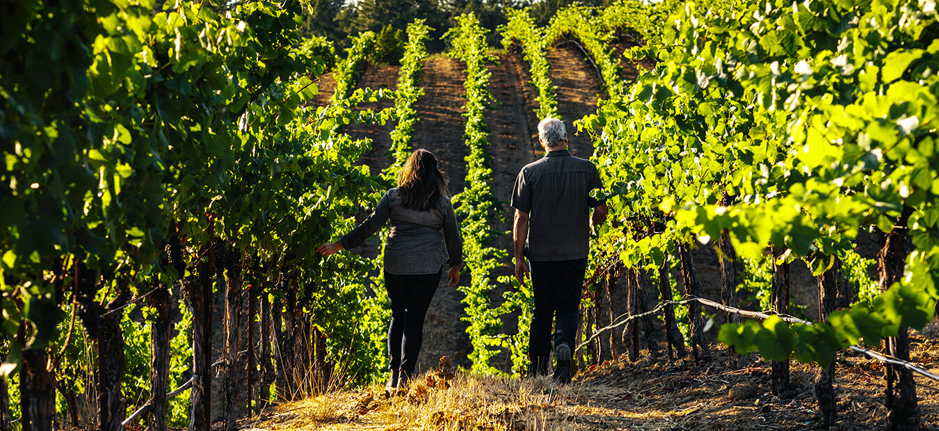 Maggy Hawk Winemakers walking in a vineyard