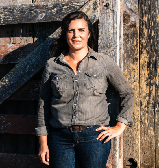 Sarah in front of barn door